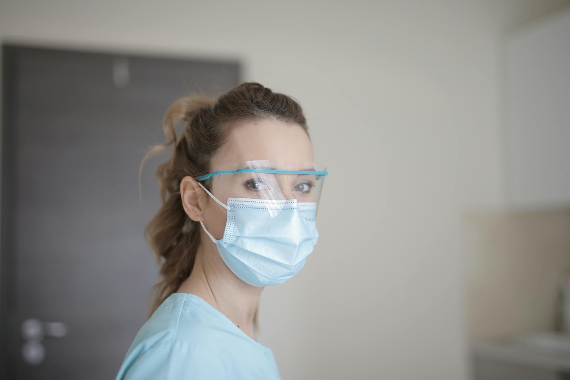 woman in blue shirt wearing face mask